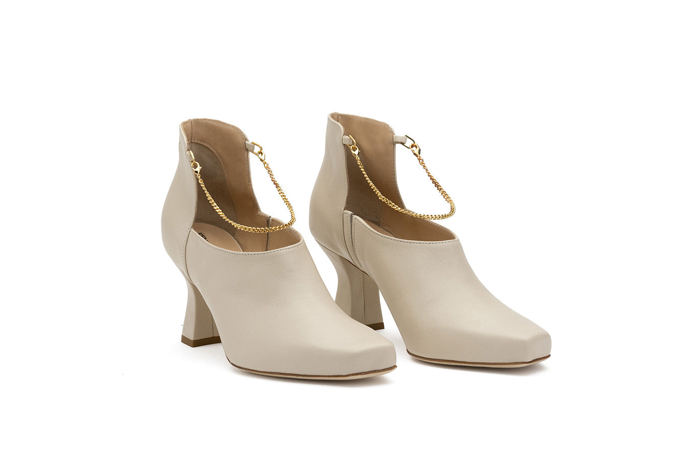 Pair of Ivory boot shoes for ladies shot at the side on a white background