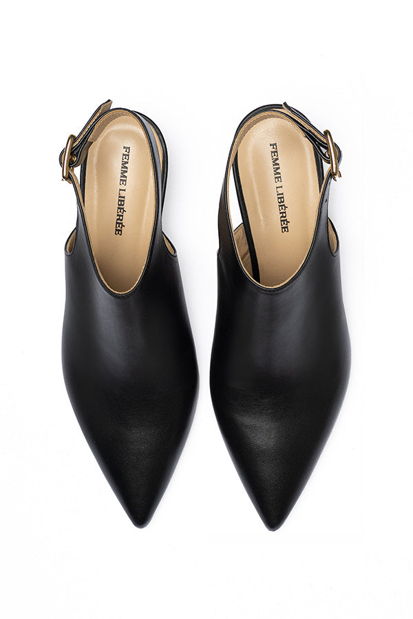 Black Buckle Shoes on a white background shot from above that insloe a written FEMME LIBERE