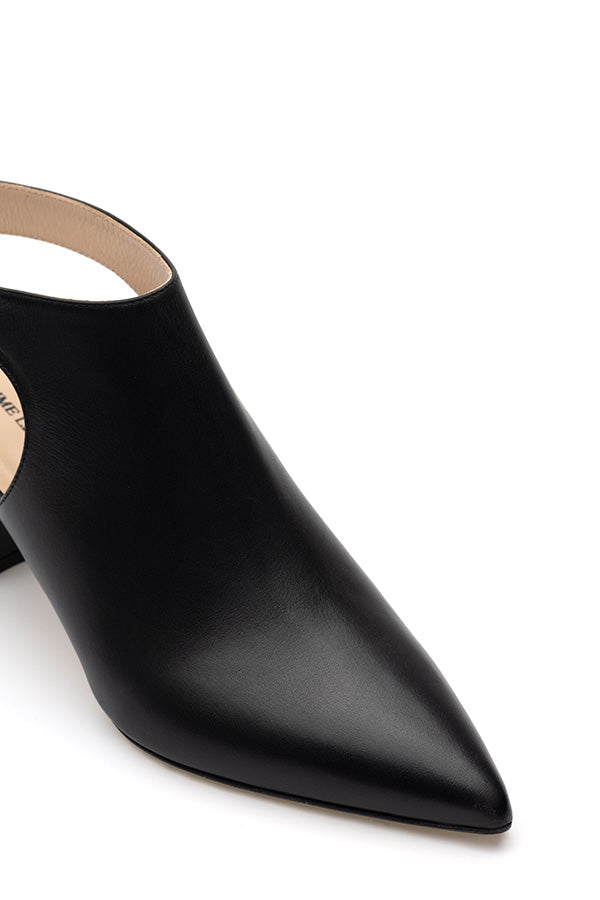Black shoe with buckle shot from the side and above on a white background