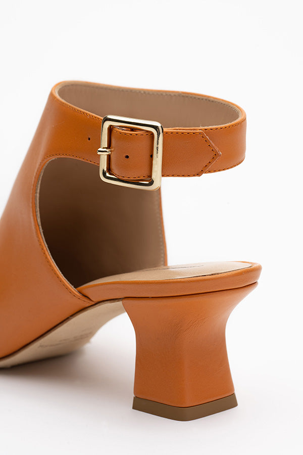 Brown buckle shoe on a white background shot from behind