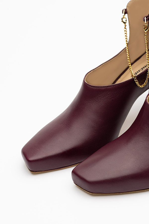 Kate mulberry shoe boots that only one shoe in focus shot at angle and above on a white background