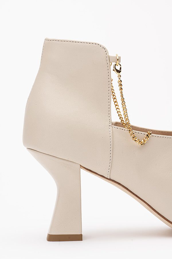 Shot from the side and with focus on the 75 MM heel of Kate Ivory ShoeBoot on white background shot from the side