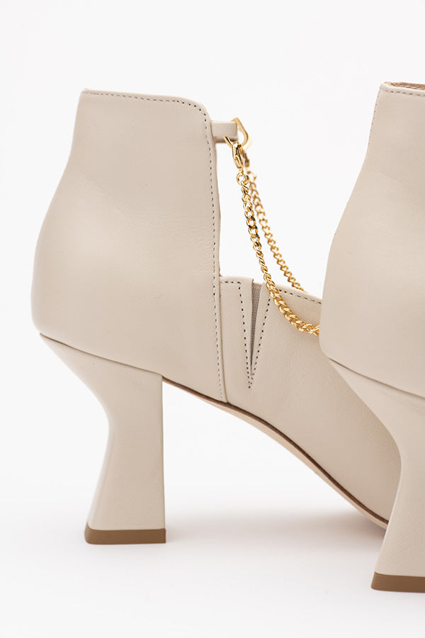 Pair of Kate ivory shoes boots shot from the side with only one in focus on the 75 MM heel