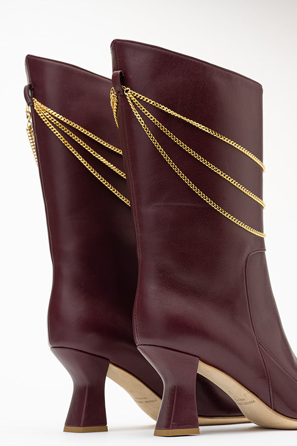 A shot of the 70 MM heel Naomi Mulberry Boot backside