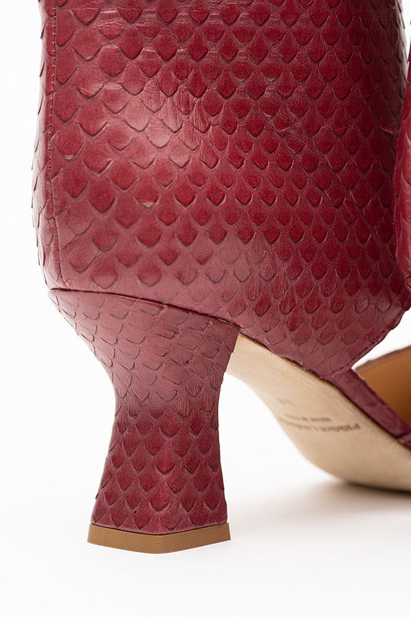 Zoom in on the Tyra RedCherry Python Print OpenBoot 70 mm heel  shot at an anglle from the back 