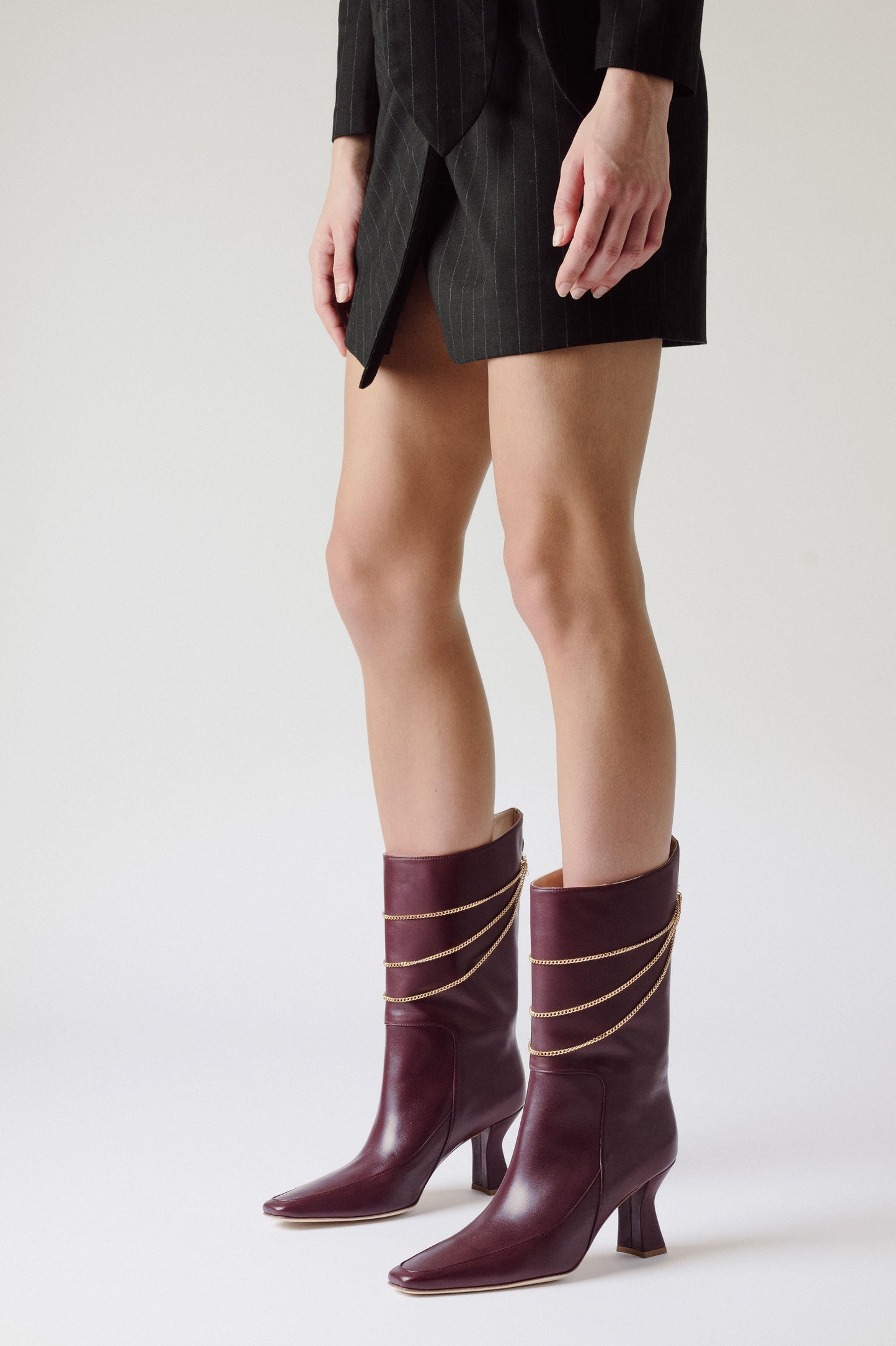 woman legs with Naomi Mulberry Boots in grey room