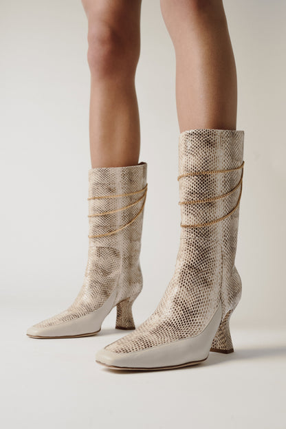 woman legs with python leather boots Naomi Ivory Python Print Boot in grey room